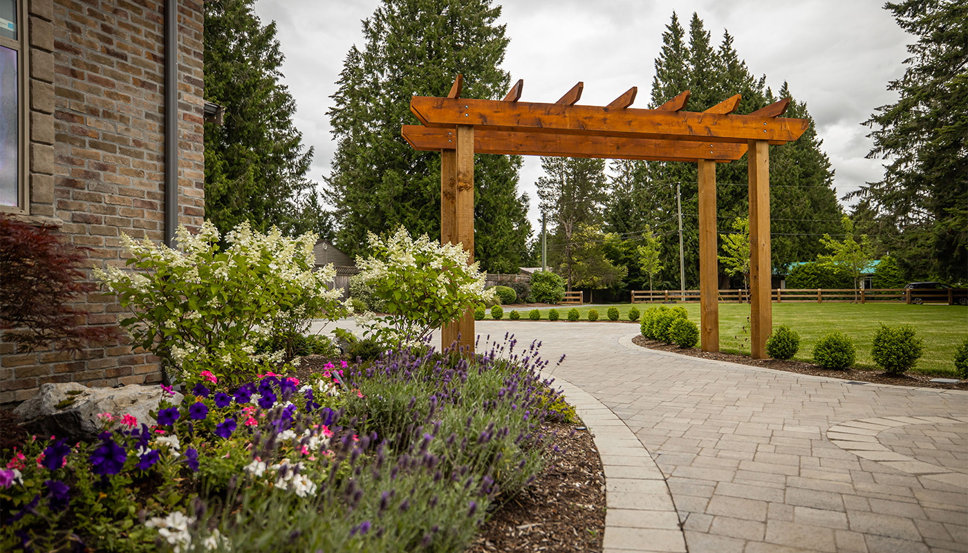 stone path with flowers and arbour