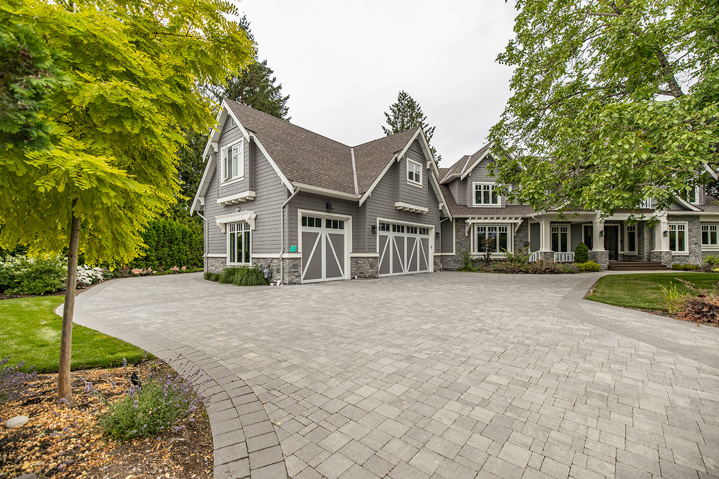 stone paver driveway with large house