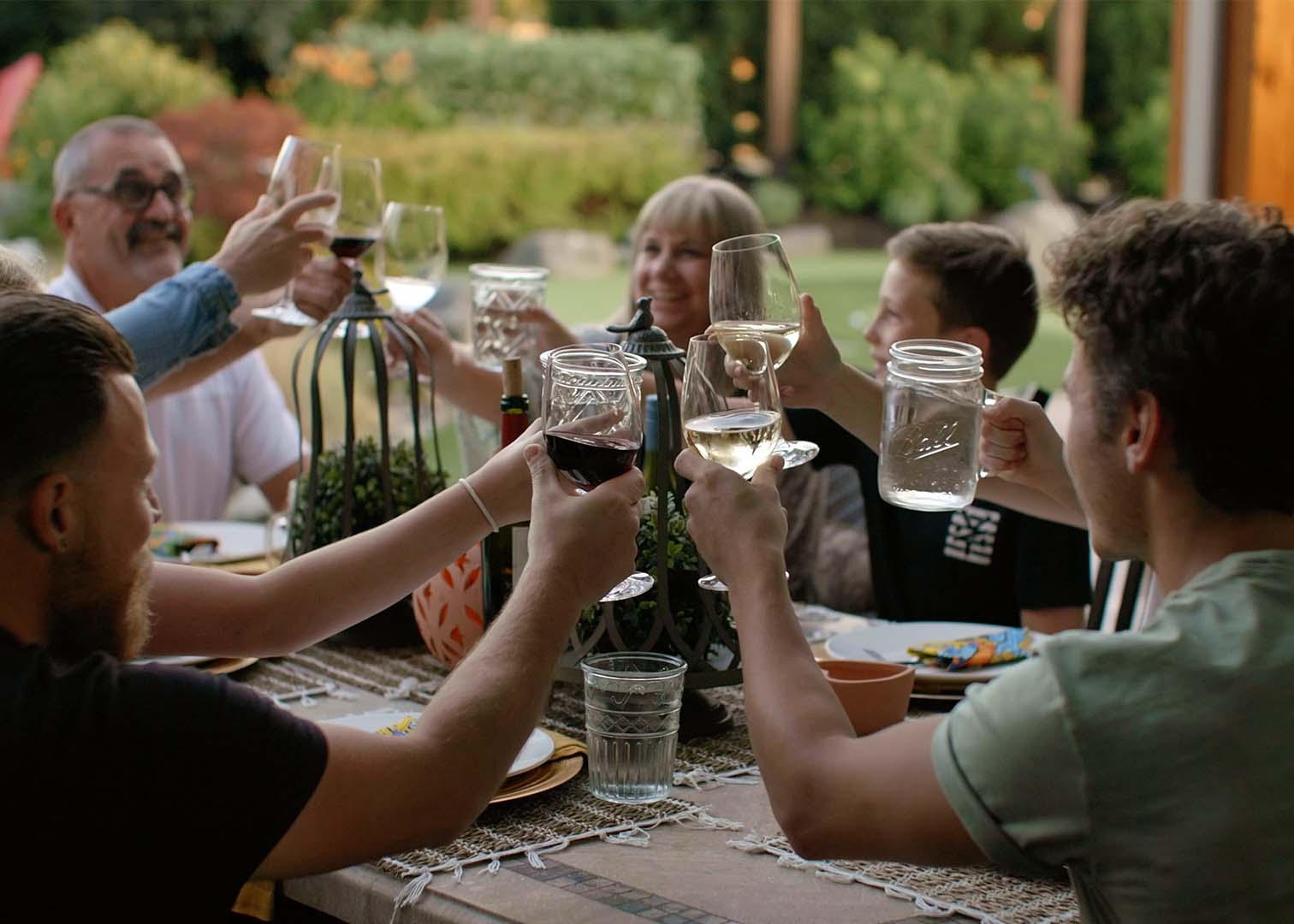 people cheering with wine glasses