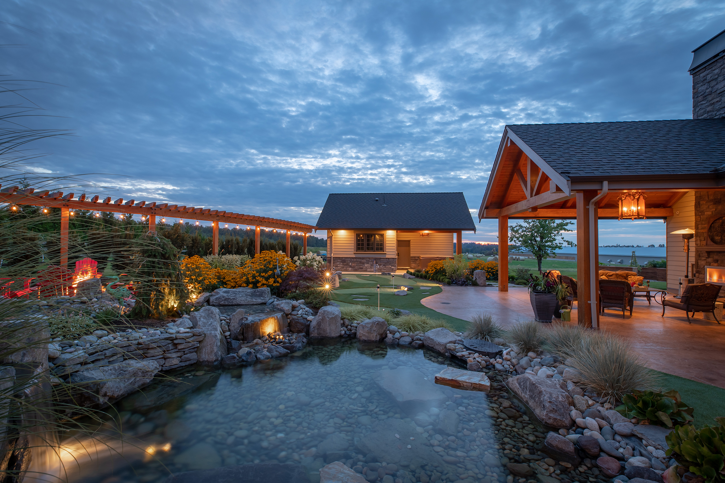 backyard at night with pond and mini putt