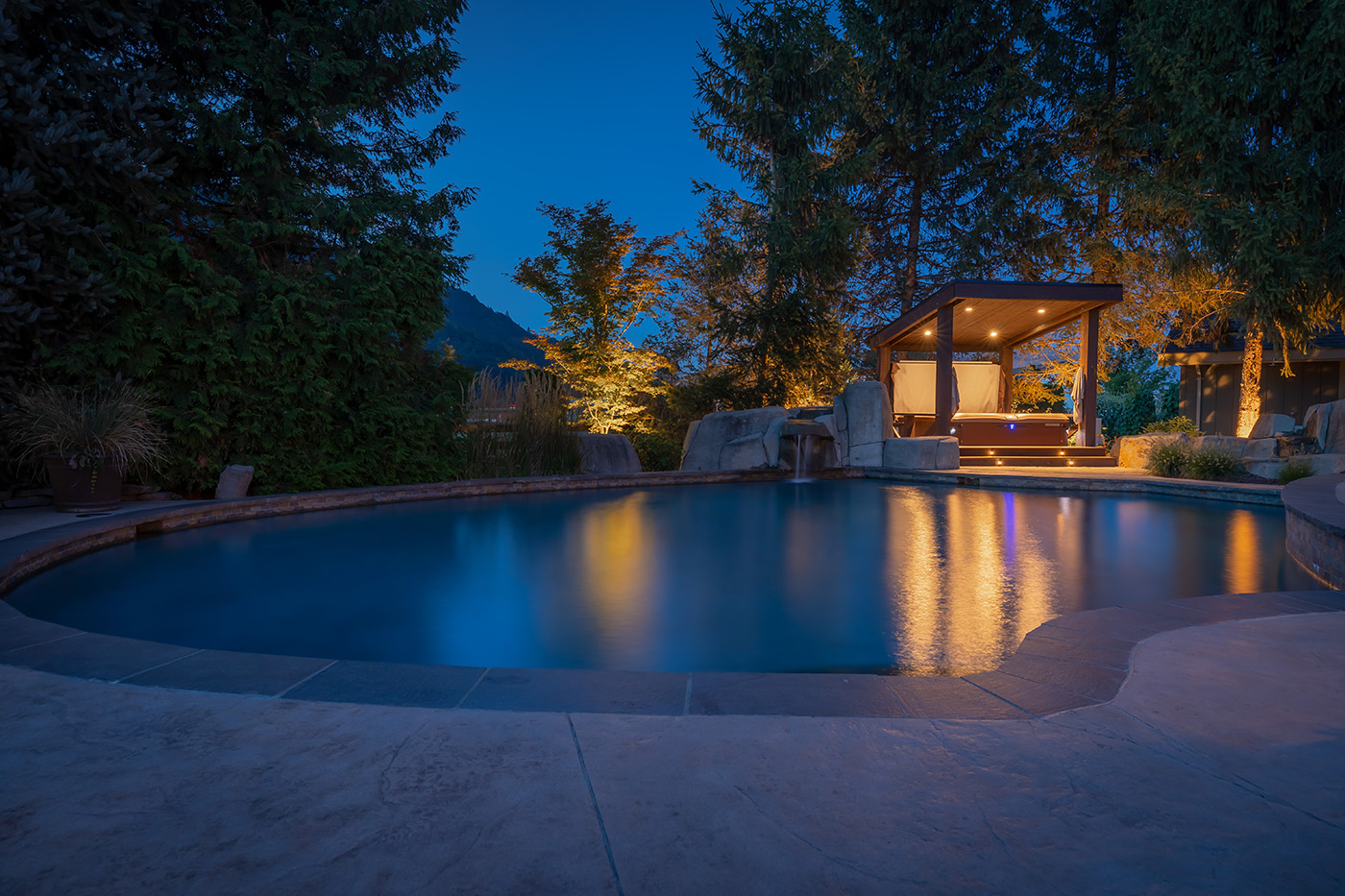 pool with hot tub light at night